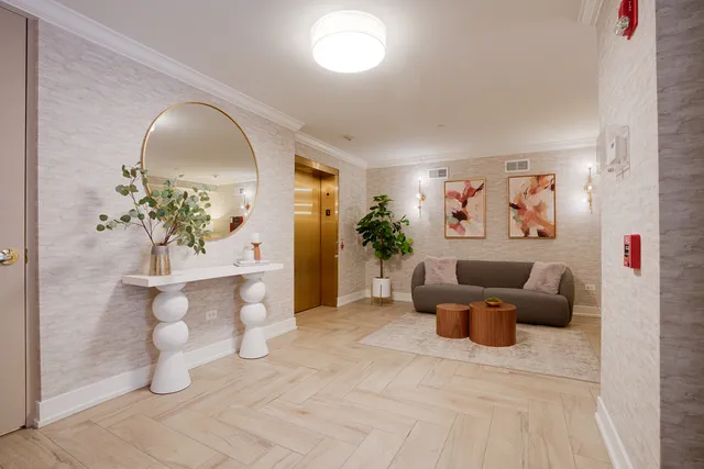 a living room with furniture and a potted plant