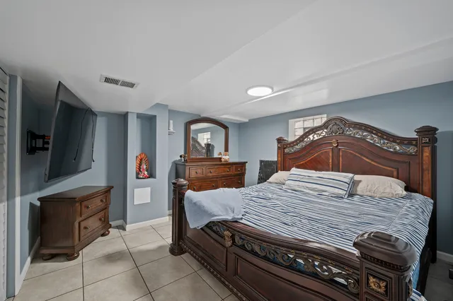 a bedroom with a bed and a television