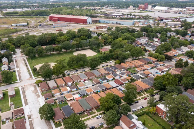 an aerial view of residential houses with outdoor space and river