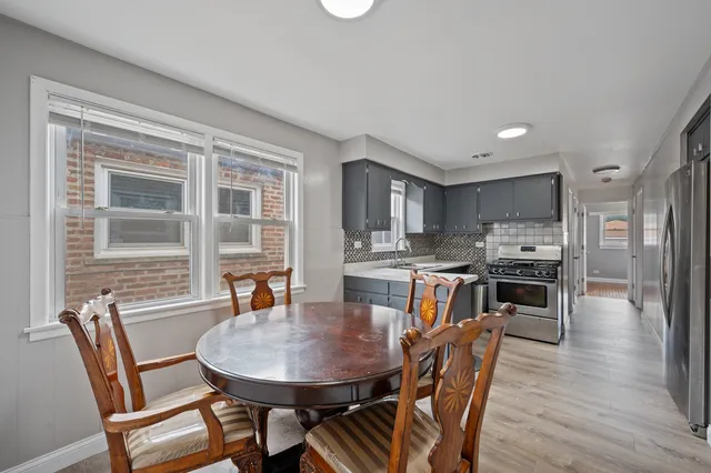 a view of a dining room with furniture and wooden floor
