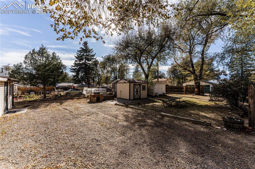 632 Sunset Road Colorado Springs, CO 80909 - Photo 3 of 13 a view of a yard with cars parked on the road