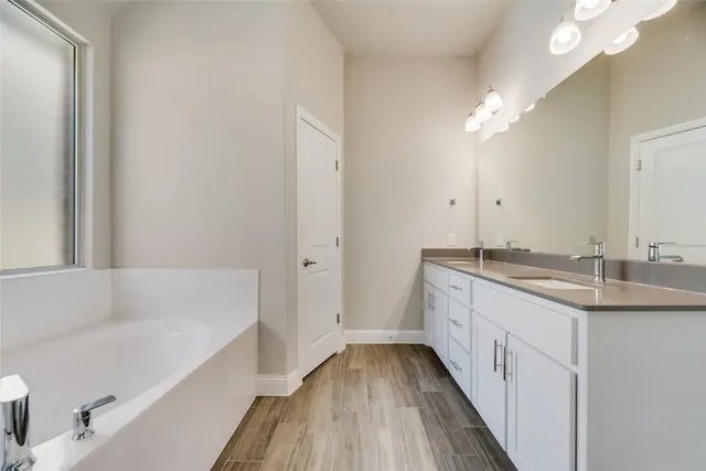 a white bath tub sitting next to a shower