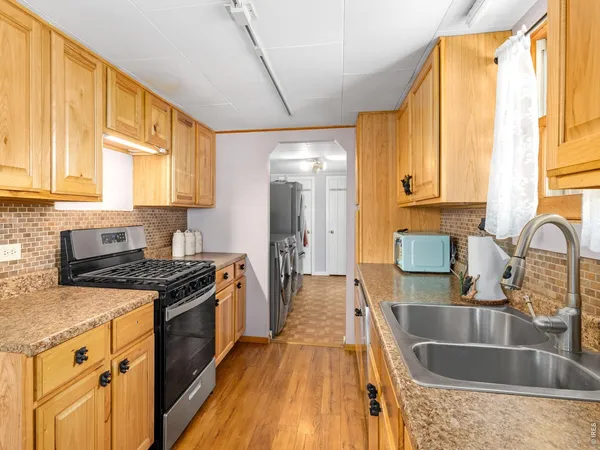 a kitchen with a sink stove and cabinets