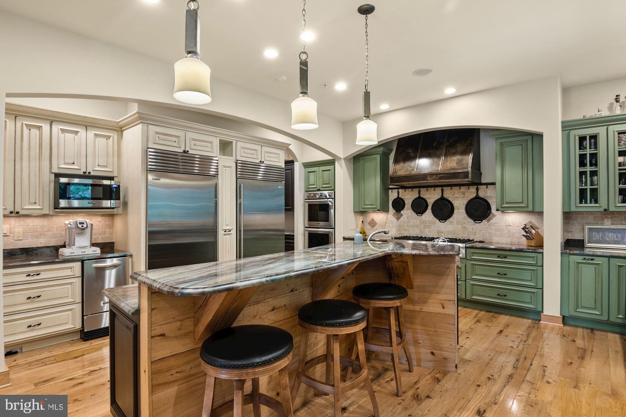 7400 Nevis Road Bethesda, MD 20817 - Photo 14 of 47 a kitchen with stainless steel appliances a sink and a table