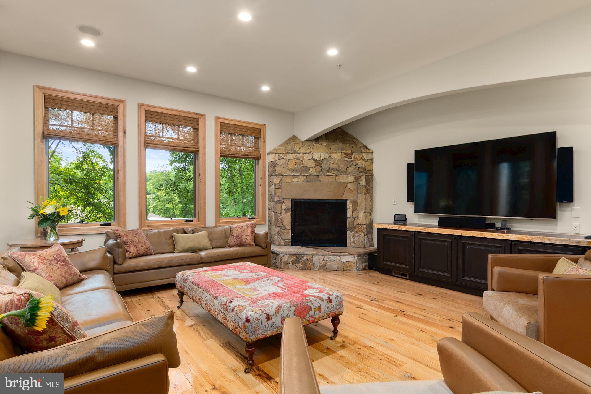 7400 Nevis Road Bethesda, MD 20817 - Photo 20 of 47 a living room with furniture a flat screen tv and a fireplace