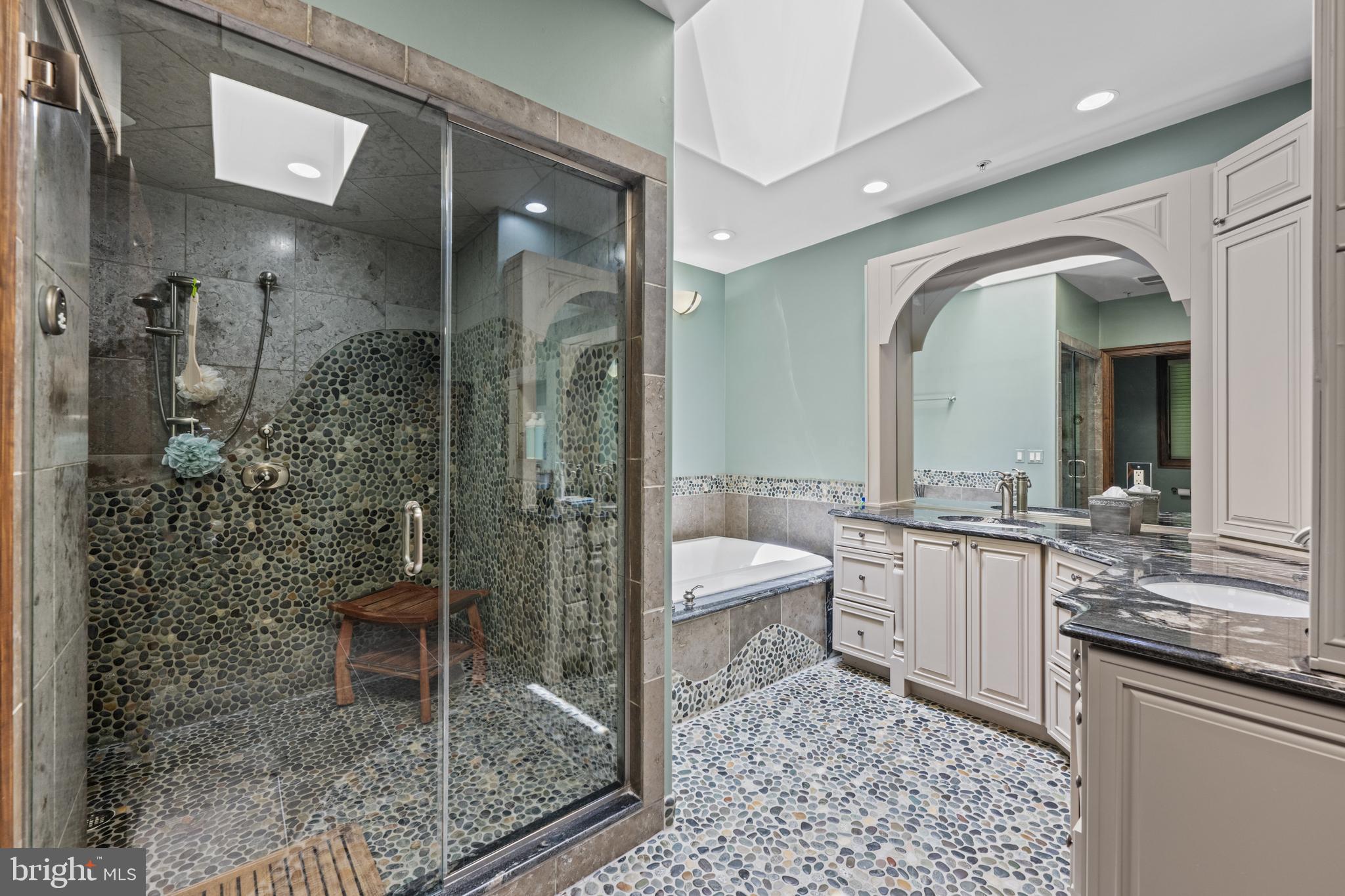 7400 Nevis Road Bethesda, MD 20817 - Photo 27 of 47 a bathroom with a granite countertop sink a toilet a mirror and shower