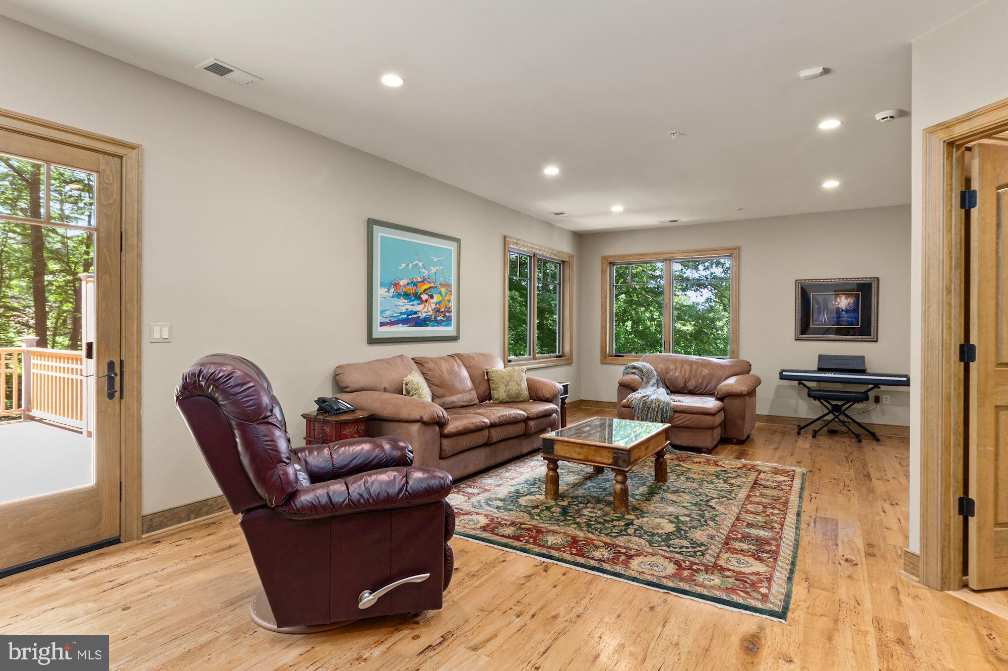 7400 Nevis Road Bethesda, MD 20817 - Photo 29 of 47 a living room with furniture a rug and a large window