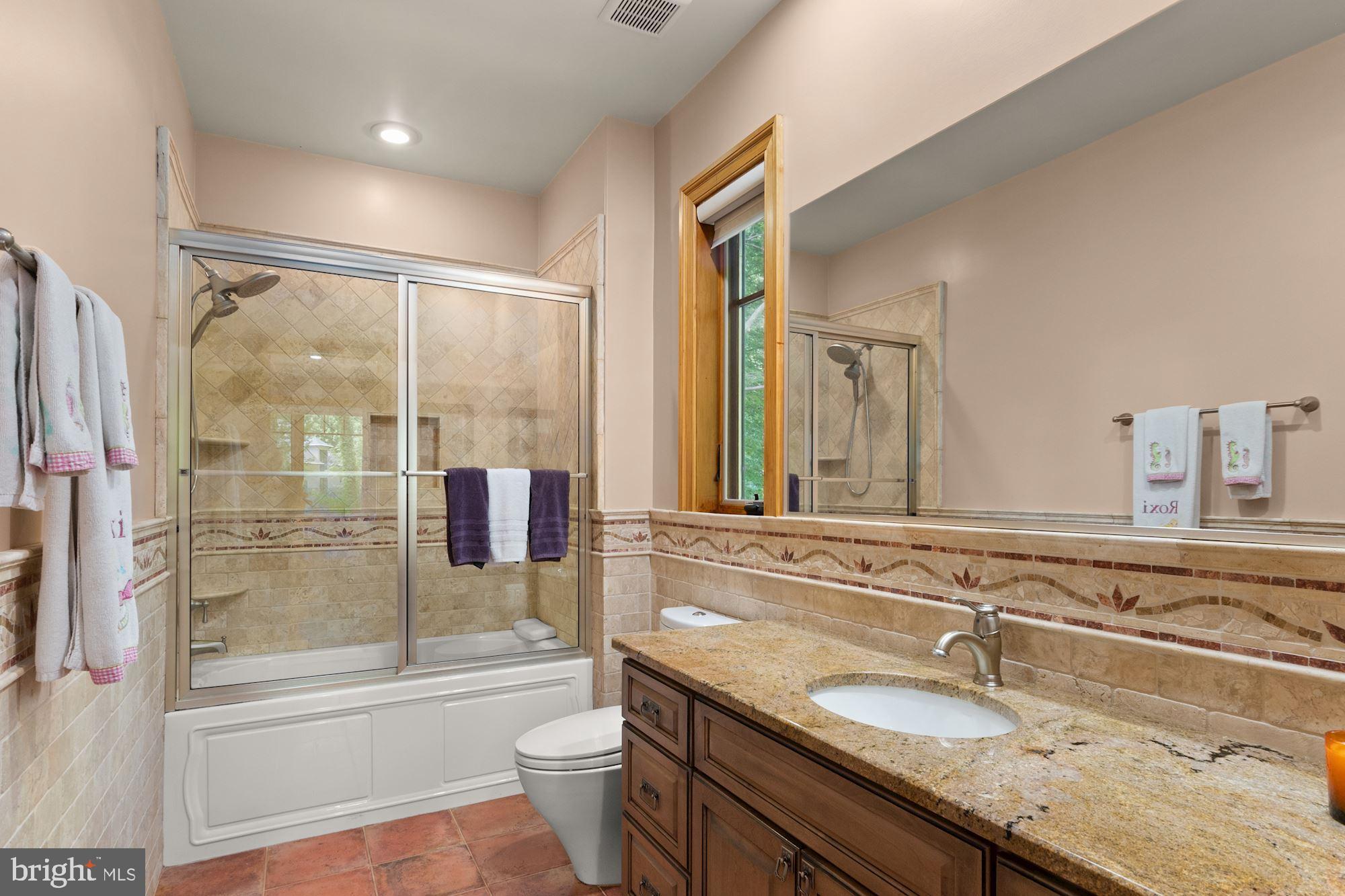 7400 Nevis Road Bethesda, MD 20817 - Photo 34 of 47 a bathroom with a granite countertop sink and a mirror