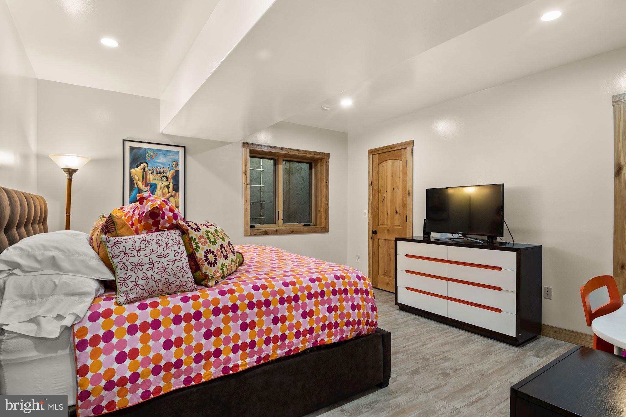 7400 Nevis Road Bethesda, MD 20817 - Photo 42 of 47 a bedroom with a bed and a flat screen tv