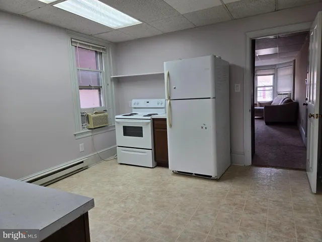 a kitchen with stainless steel appliances a refrigerator sink and stove