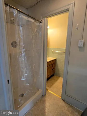 a bathroom with a glass shower door