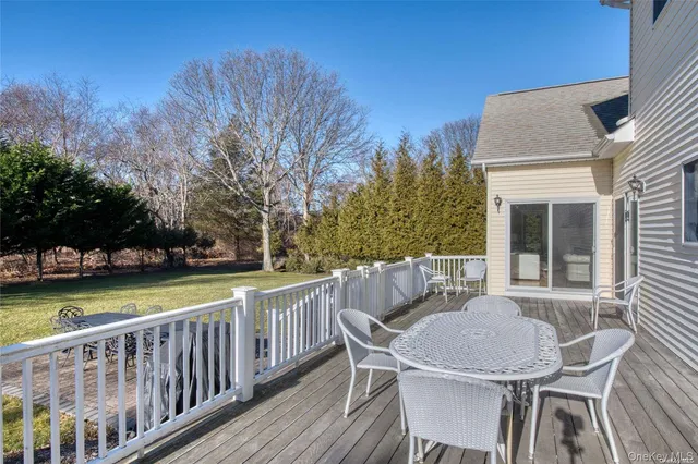 a view of a patio with table and chairs and wooden floor