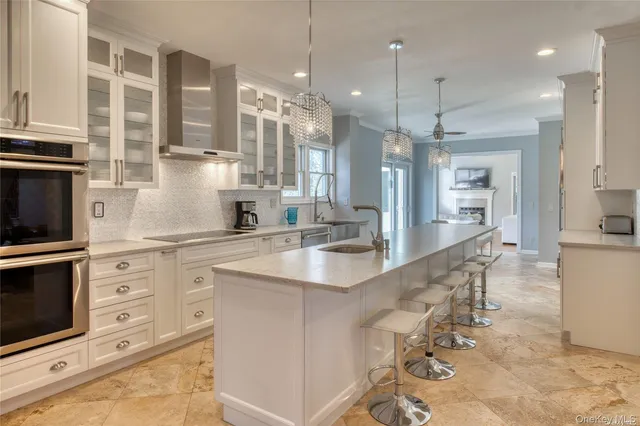 a large kitchen with granite countertop lots of counter space and a sink