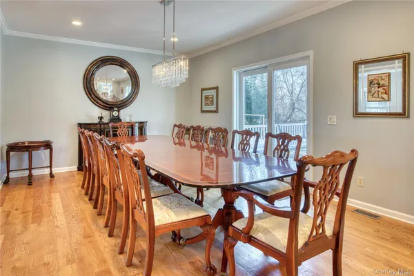 a view of a dining room with furniture and chandelier