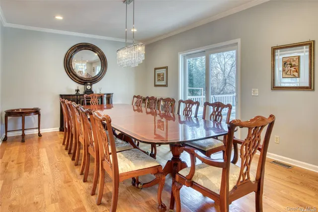 a view of a dining room with furniture and chandelier
