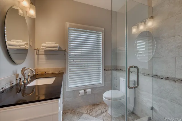 a bathroom with a sink toilet and shower