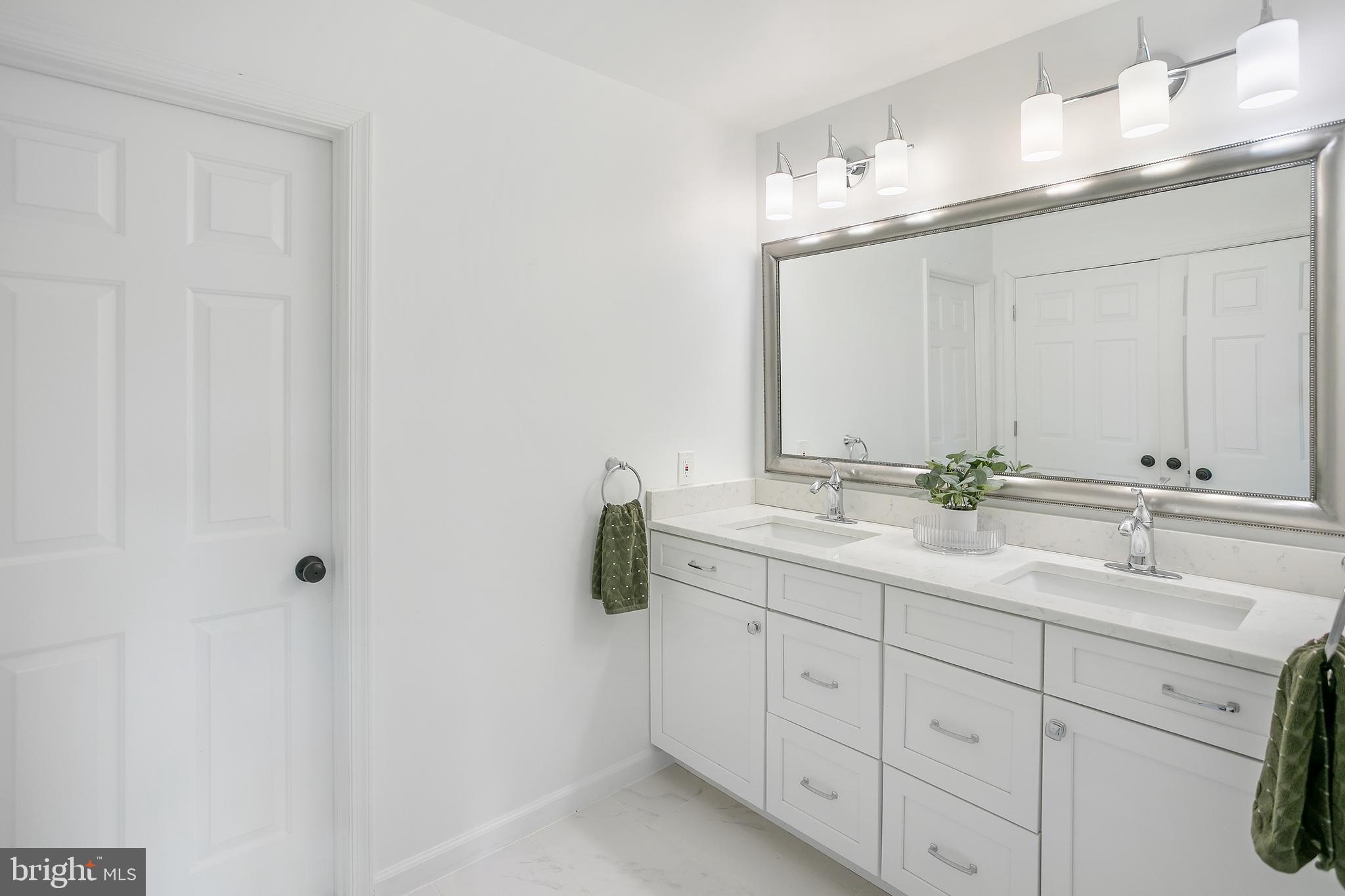 11946 Ropp Lane Lovettsville, VA 20180 - Photo 16 of 48 a bathroom with a double vanity sink and mirror