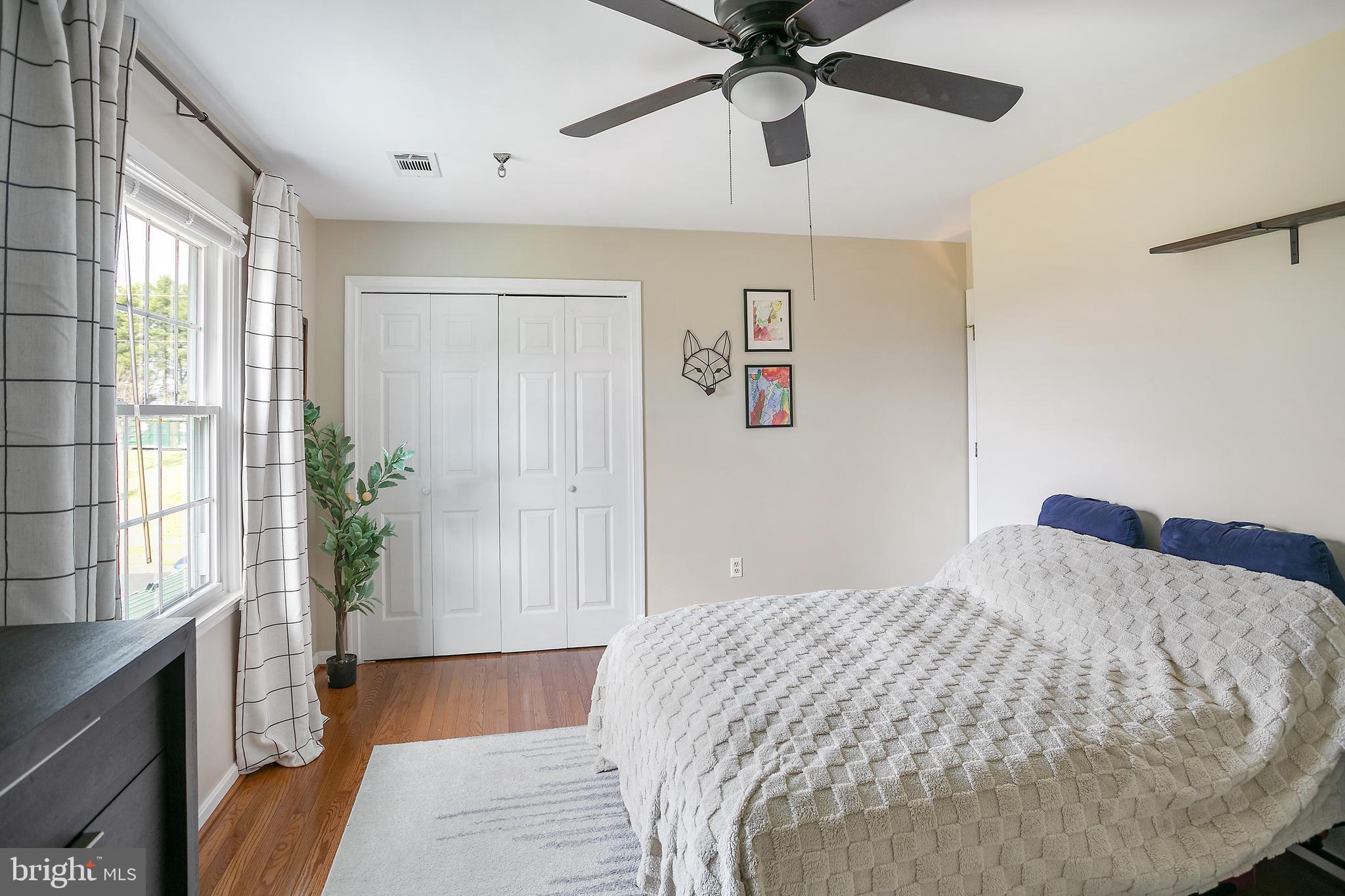 11946 Ropp Lane Lovettsville, VA 20180 - Photo 20 of 48 a bedroom with a large bed and a chandelier