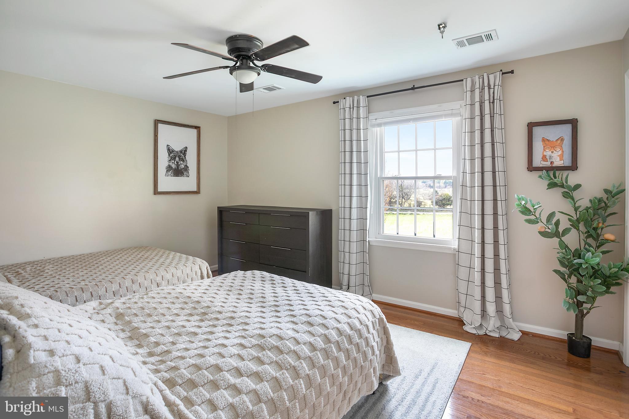 11946 Ropp Lane Lovettsville, VA 20180 - Photo 21 of 48 a bedroom with a bed and a potted plant