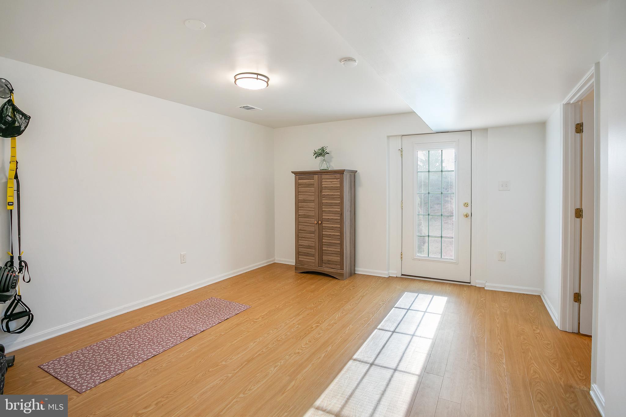 11946 Ropp Lane Lovettsville, VA 20180 - Photo 25 of 48 a view of an empty room with wooden floor and a window