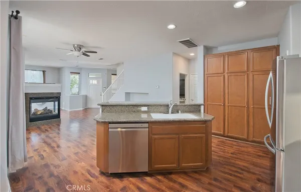 a kitchen with stainless steel appliances granite countertop a stove a sink and a refrigerator