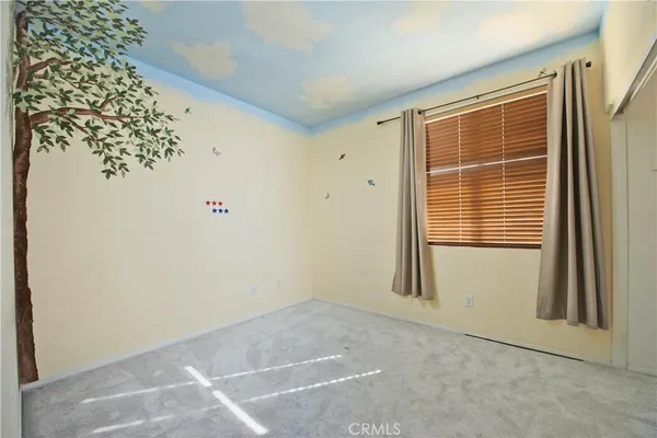 a view of a livingroom with a ceiling fan and window