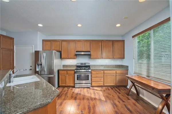 a kitchen with wooden floors and wooden cabinets