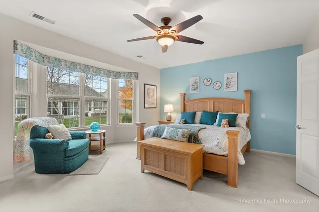 a bedroom with a bed and a large window