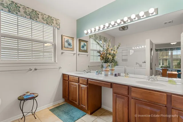 a bathroom with a double vanity sink and a mirror