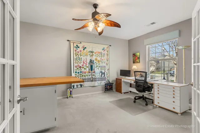 a view of a livingroom with workspace and a window
