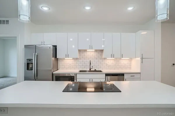 a kitchen with a sink and a refrigerator