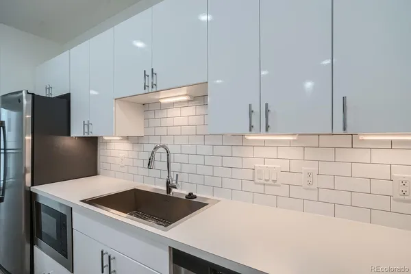 a large kitchen with kitchen island a sink stainless steel appliances and cabinets
