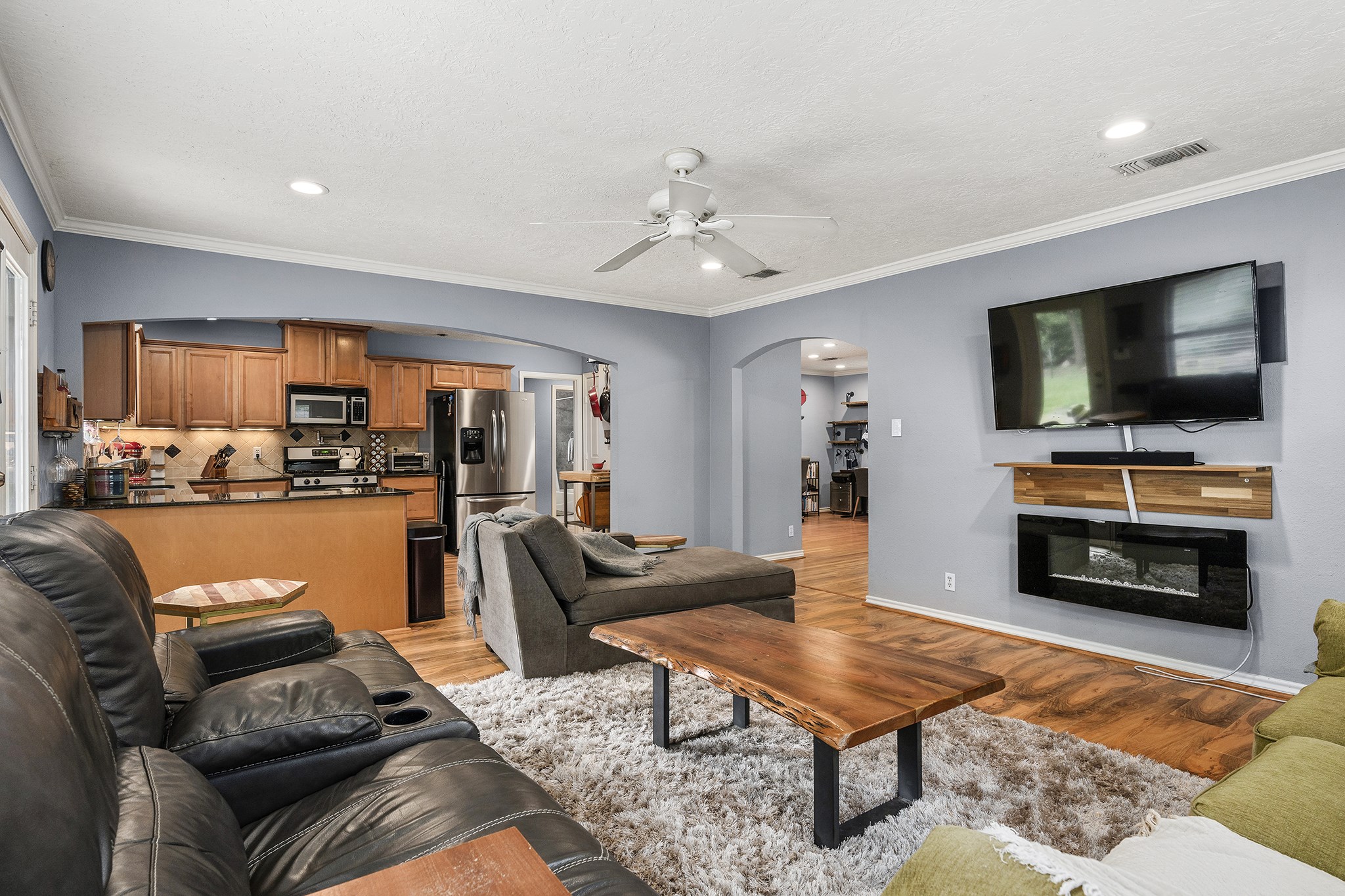 1034 Nashua Street Houston, TX 77008 - Photo 11 of 19 a living room with furniture and a flat screen tv with kitchen view