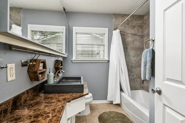 a bathroom with a tub and a window