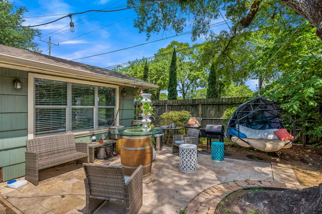 a view of a patio with table and chairs and potted plants