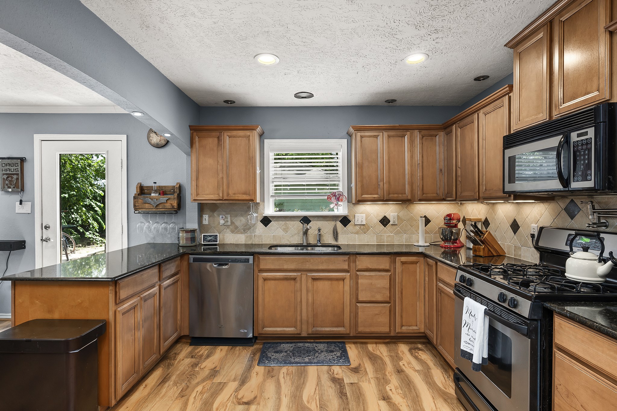 1034 Nashua Street Houston, TX 77008 - Photo 6 of 19 a kitchen with granite countertop wooden cabinets stainless steel appliances a sink and a window