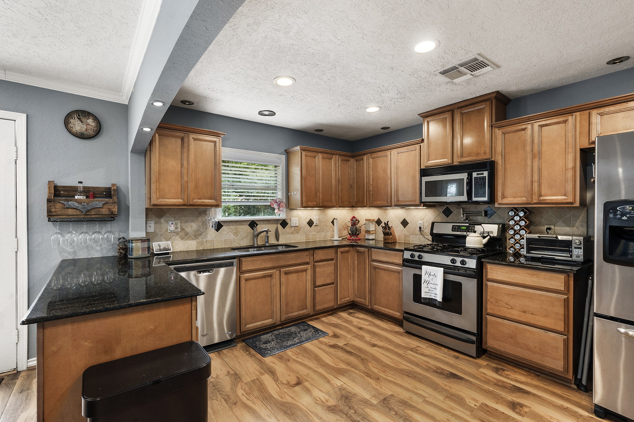1034 Nashua Street Houston, TX 77008 - Photo 7 of 19 a kitchen with granite countertop stainless steel appliances and sink