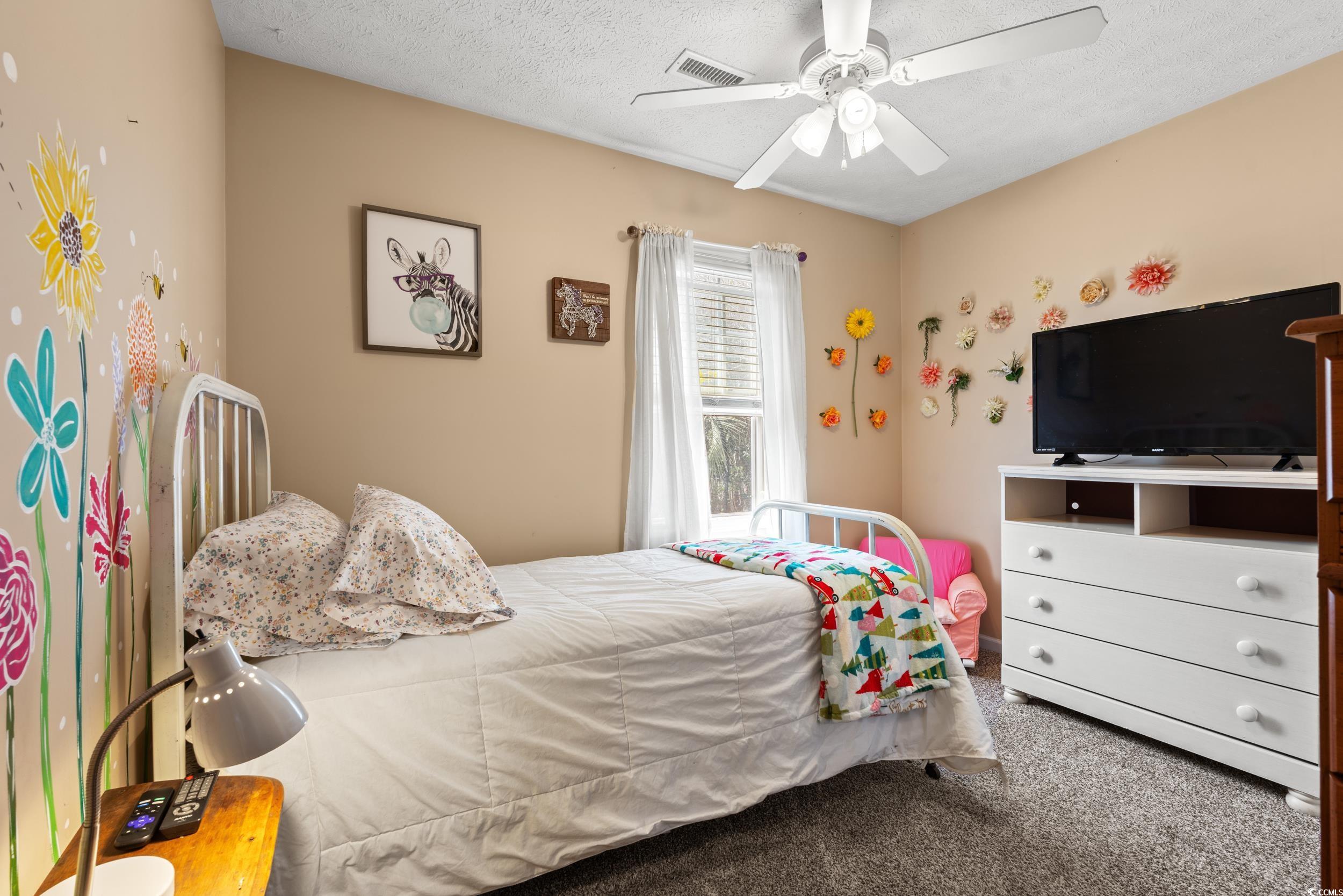 9554 Sullivan Drive Murrells Inlet, SC 29576 - Photo 20 of 35 Bedroom featuring ceiling fan, a textured ceiling,