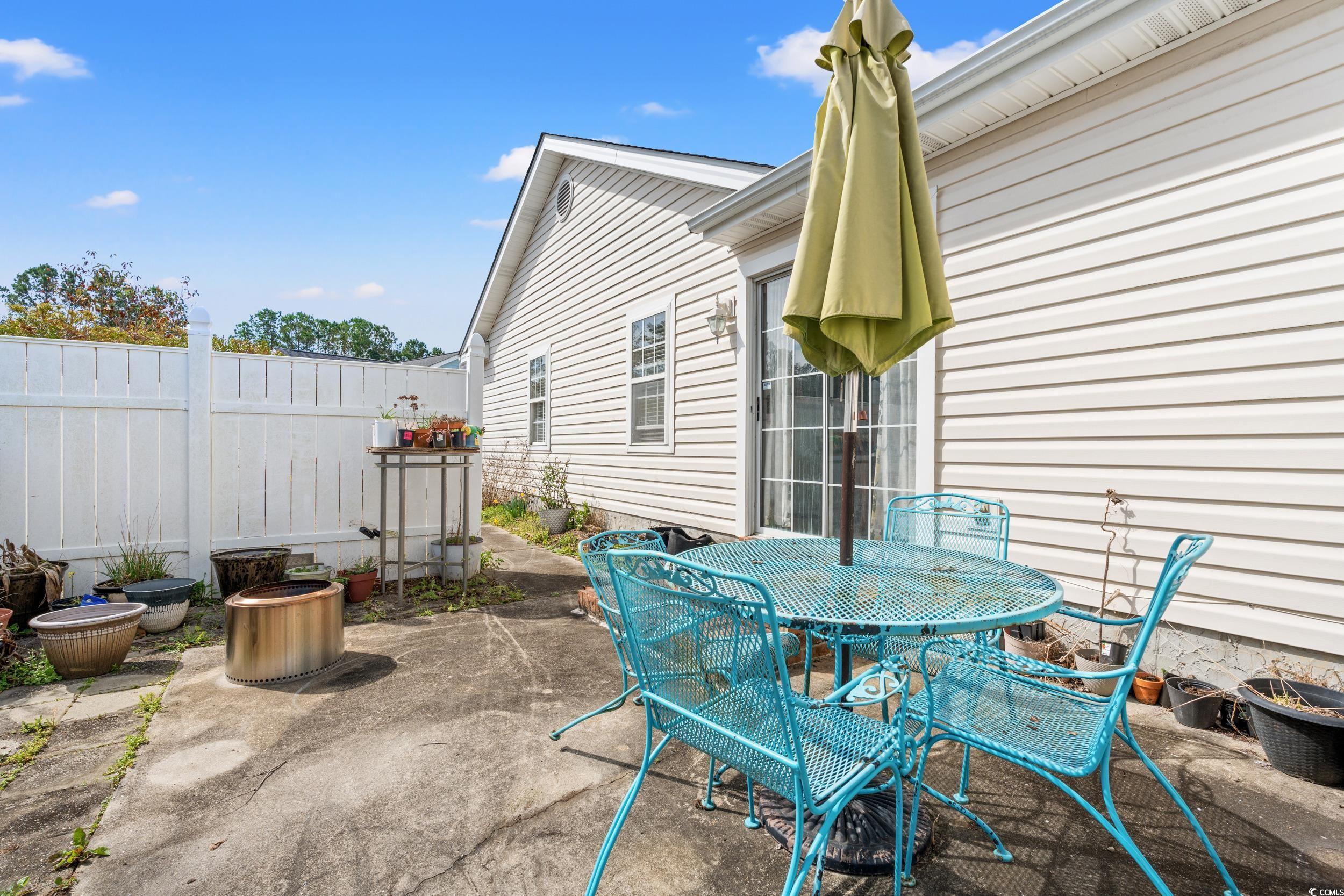 9554 Sullivan Drive Murrells Inlet, SC 29576 - Photo 27 of 35 View of patio featuring outdoor dining area and fe