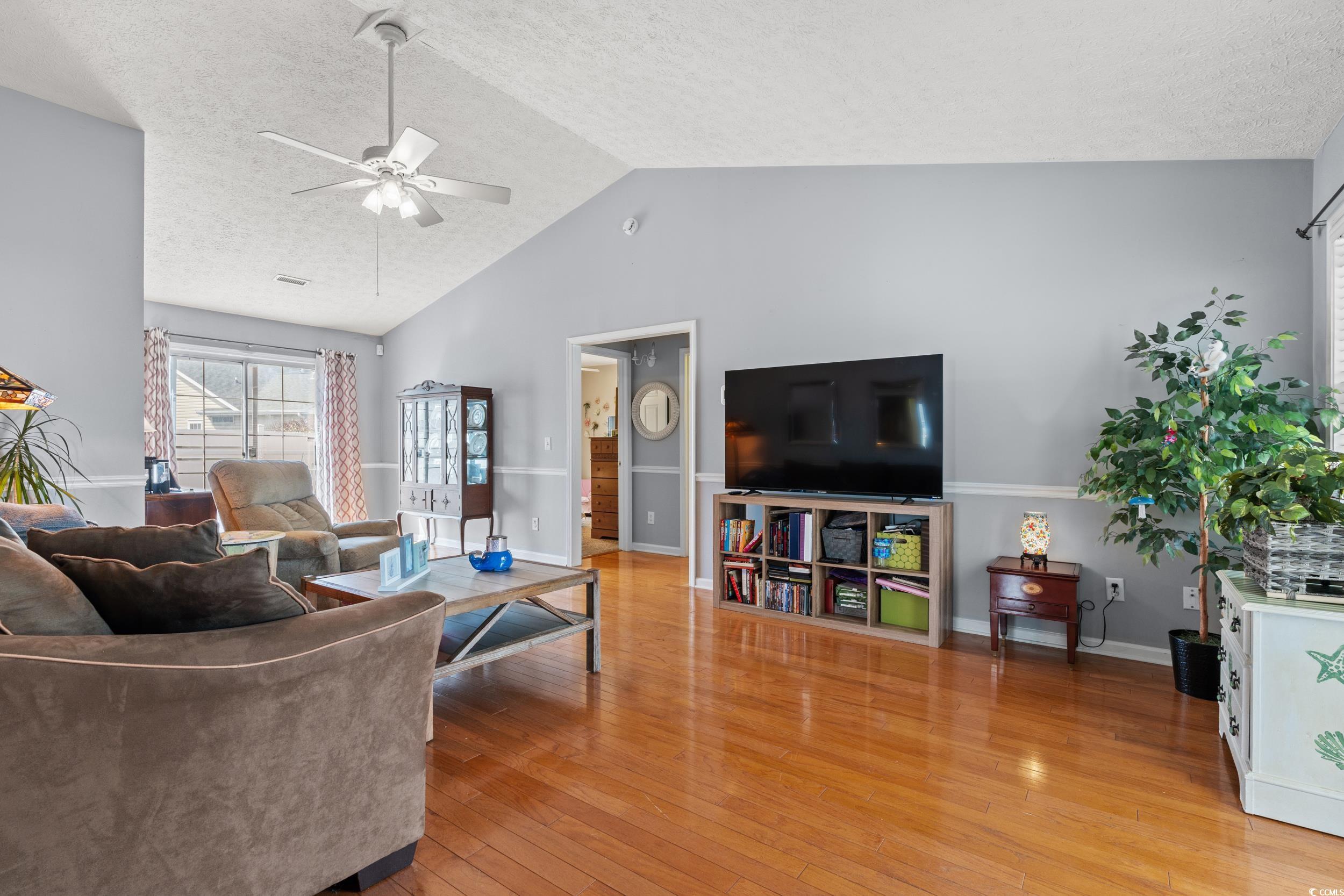 9554 Sullivan Drive Murrells Inlet, SC 29576 - Photo 5 of 35 Living room with lofted ceiling, light wood-style