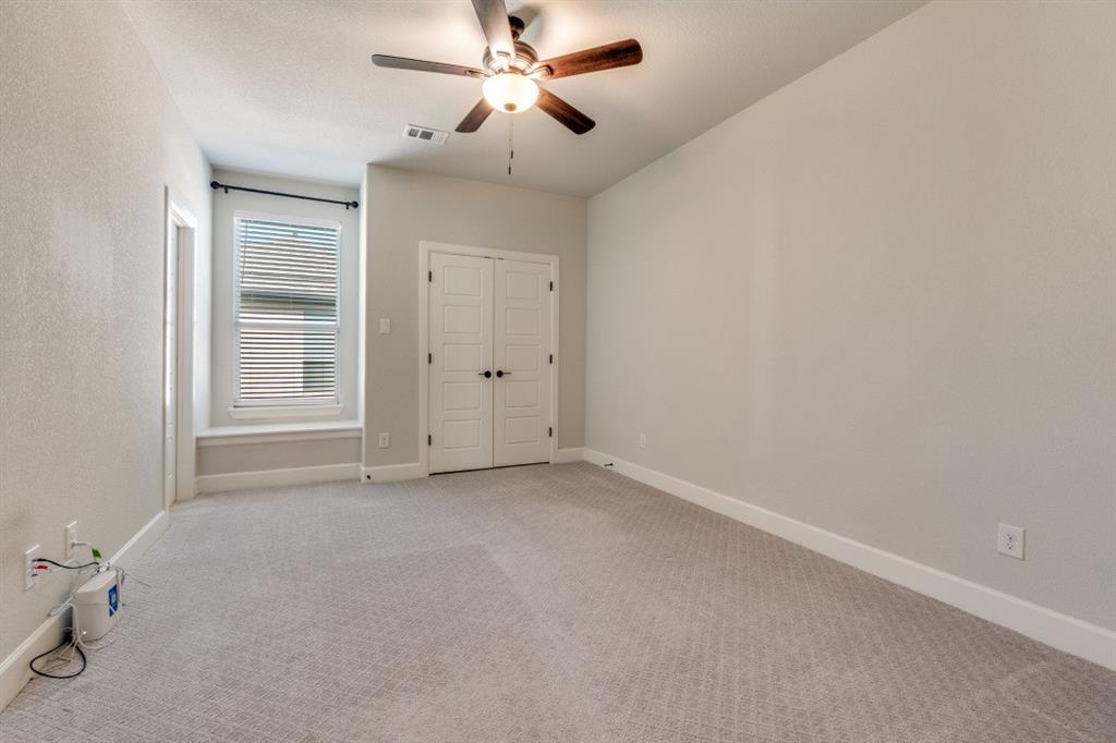 8202 Laflin Lane Dallas, TX 75231 - Photo 15 of 22 an empty room with windows and fan