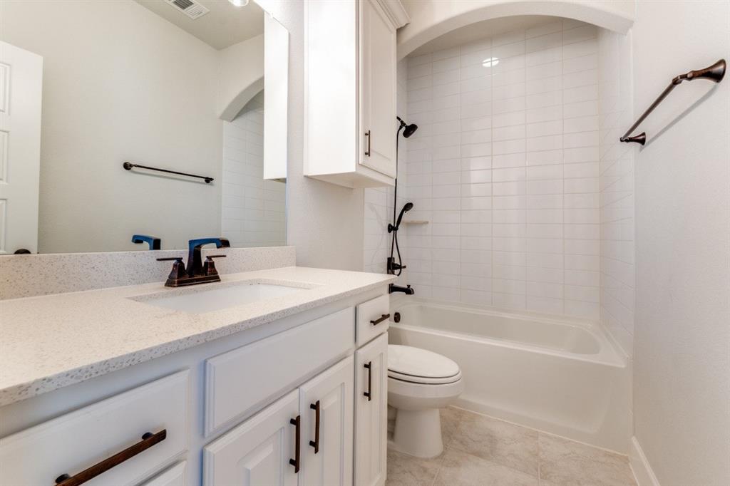 8202 Laflin Lane Dallas, TX 75231 - Photo 17 of 22 a bathroom with a granite countertop sink a toilet and shower