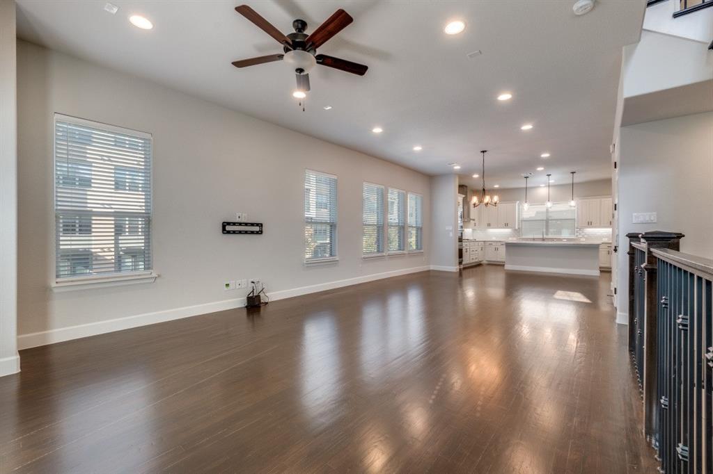 8202 Laflin Lane Dallas, TX 75231 - Photo 6 of 22 a view of an empty room with wooden floor and a window