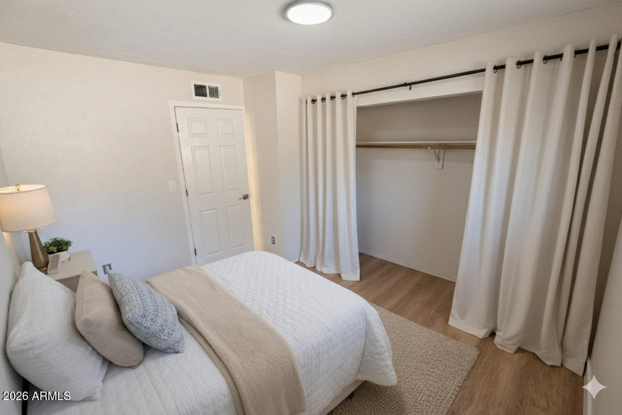 6011 West Nancy Road Glendale, AZ 85306 - Photo 8 of 11 a bedroom with a bed and a shower