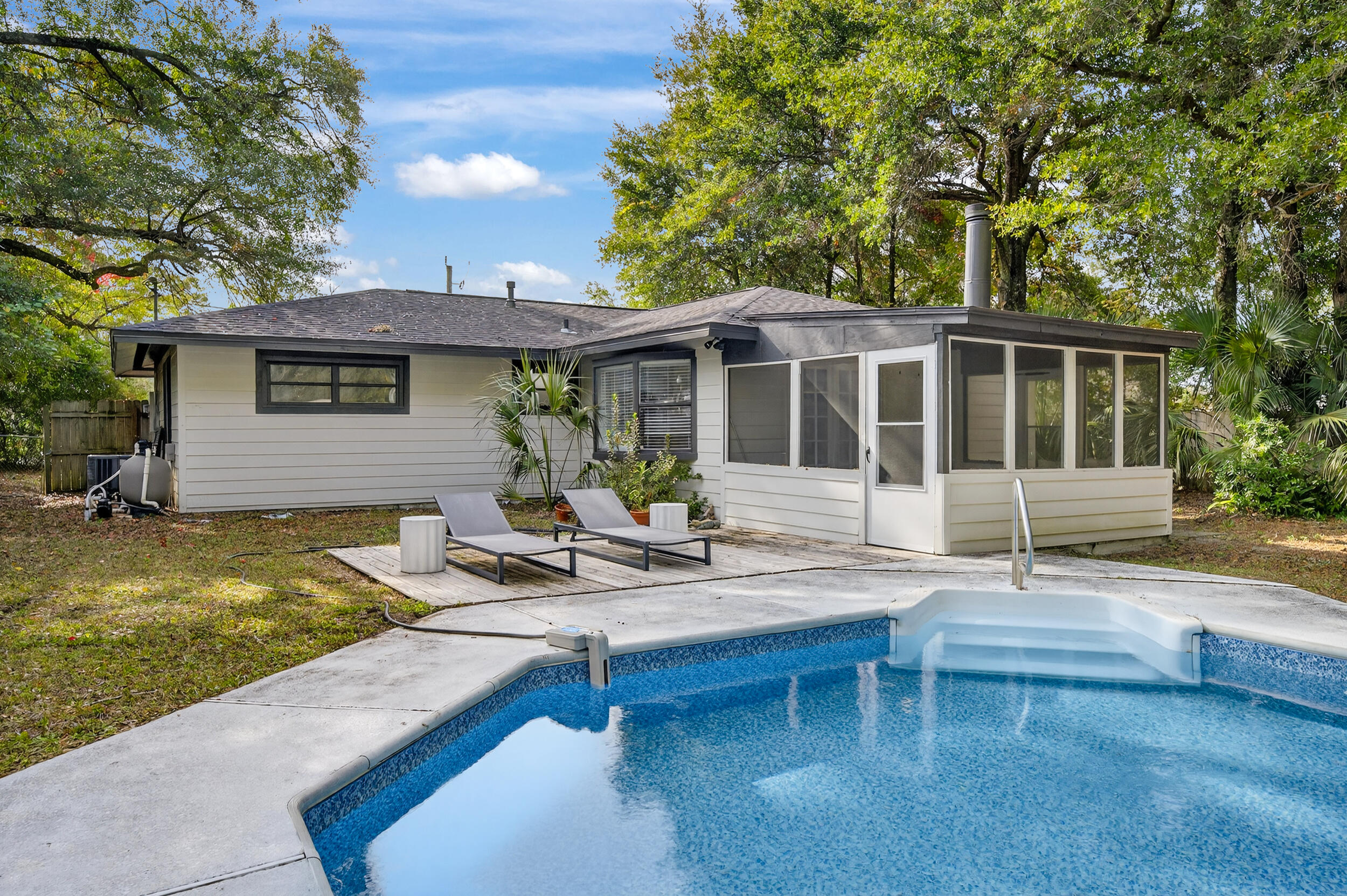 a view of a house with swimming pool and sitting area