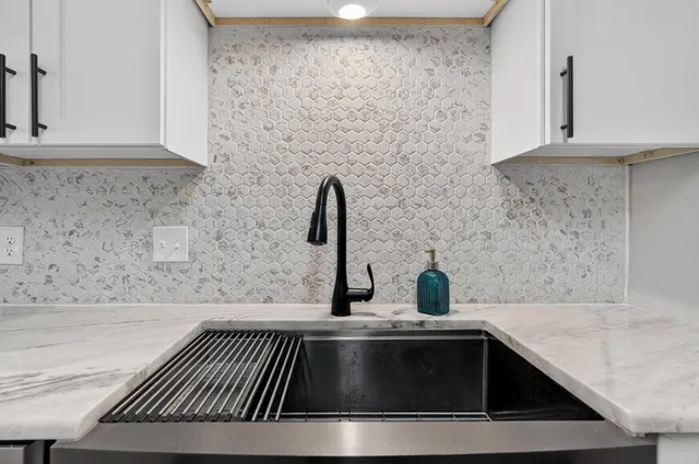 a bedroom with a large bed and a flat screen tv