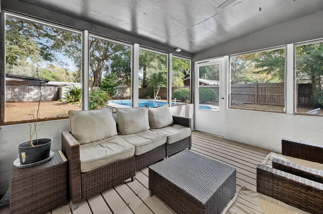 a large white kitchen with stainless steel appliances granite countertop a stove top oven a sink dishwasher and a refrigerator with wooden floor