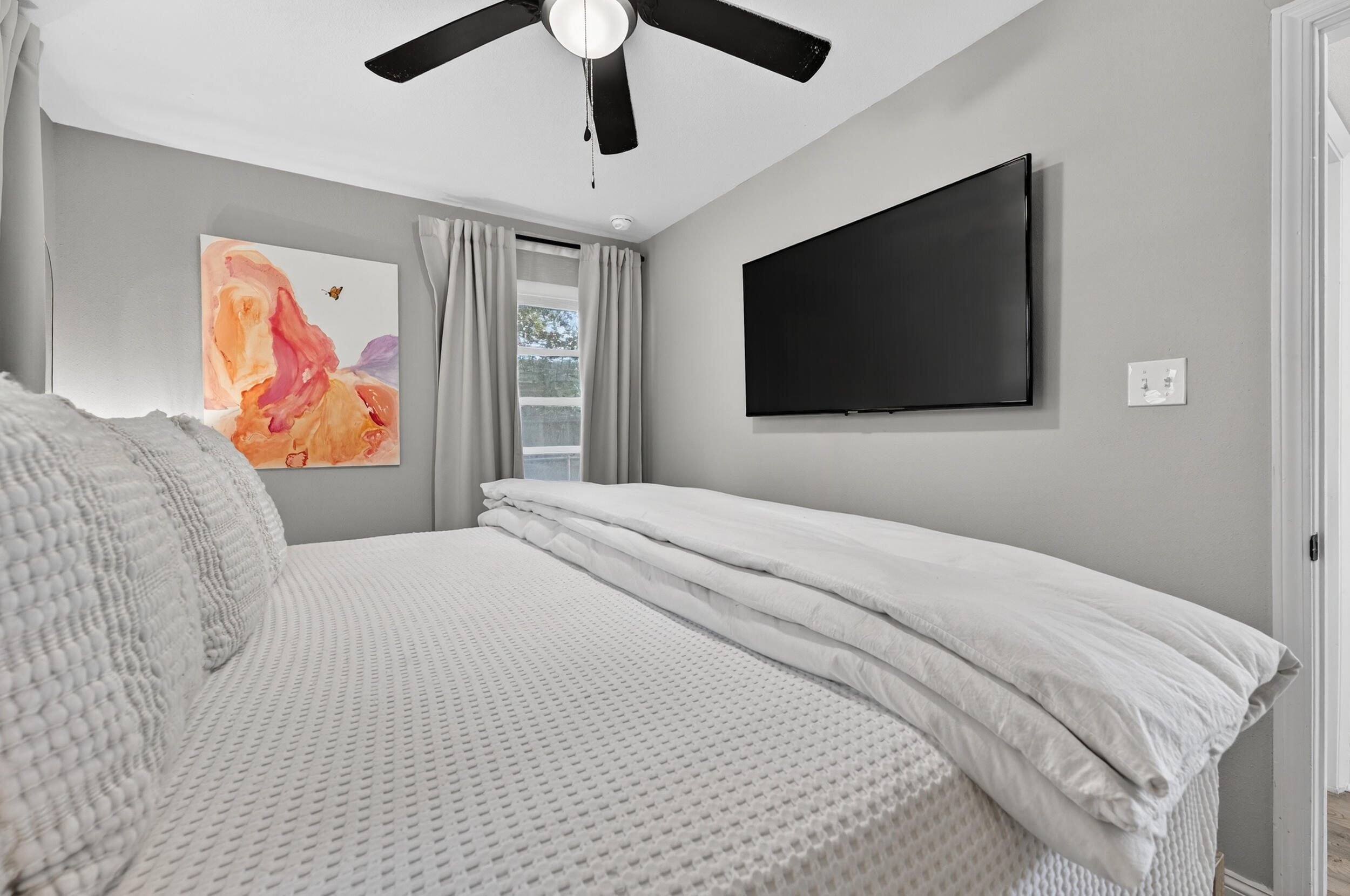 370 Edge Avenue Valparaiso, FL 32580 - Photo 31 of 58 a bedroom with a large bed and a flat screen tv