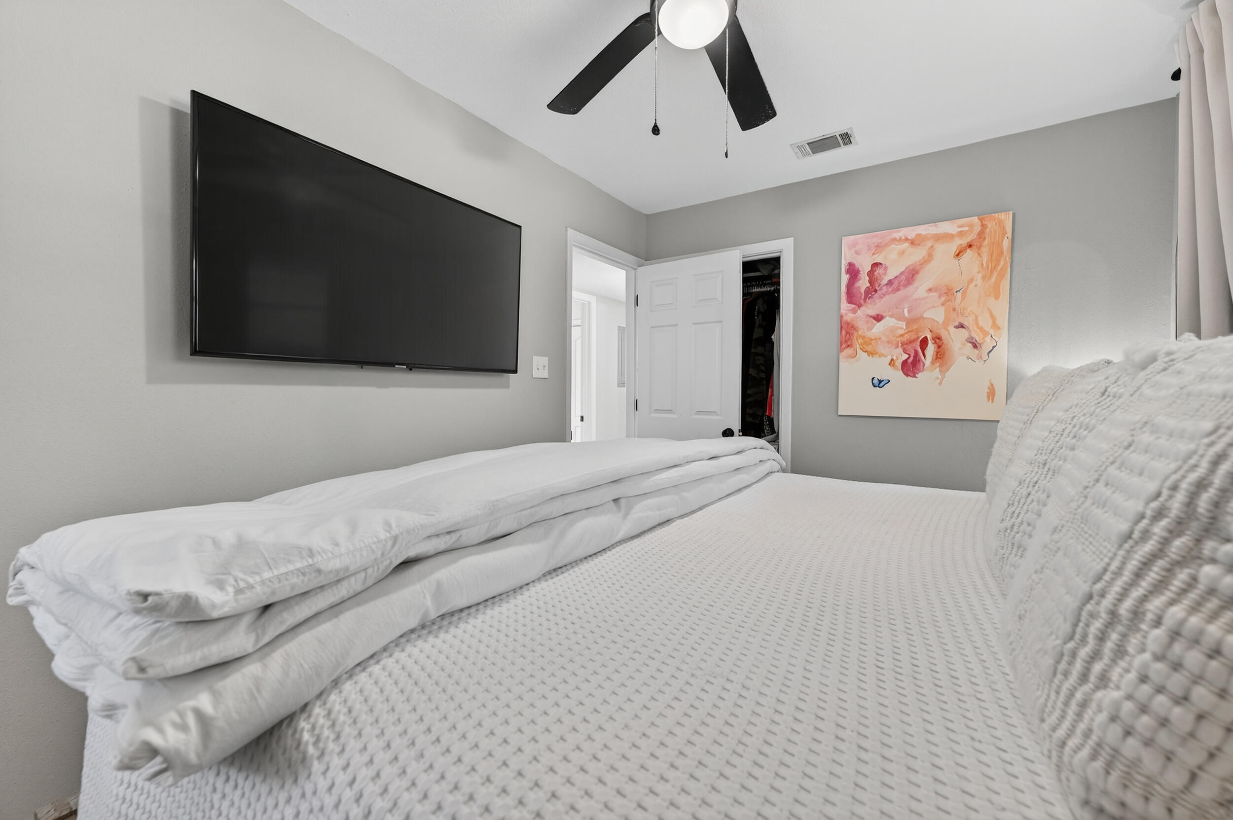 370 Edge Avenue Valparaiso, FL 32580 - Photo 32 of 58 a bedroom with a bed and a flat screen tv