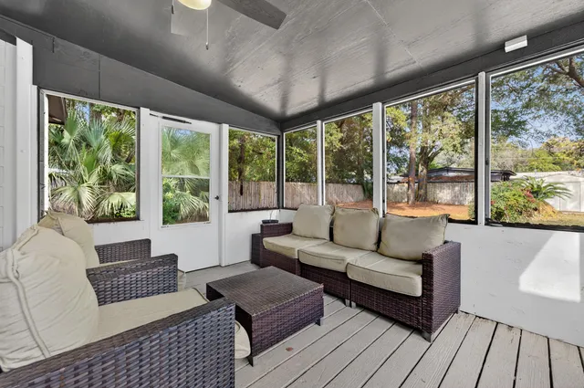 a view of a house with pool and sitting area